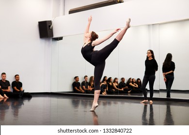 Female Ballet Student At Performing Arts School Performs For Class And Teacher In Dance Studio