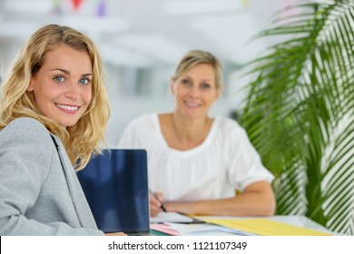 female banker and client contracting - Shutterstock ID 1121107349