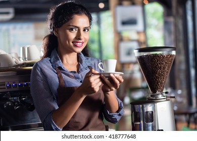 Female Barista Preparing Coffee In Indian Cafe