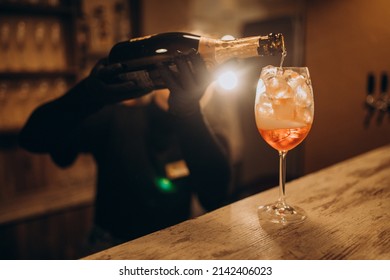Female Bartender Pouring Champaigne Into Cocktail
