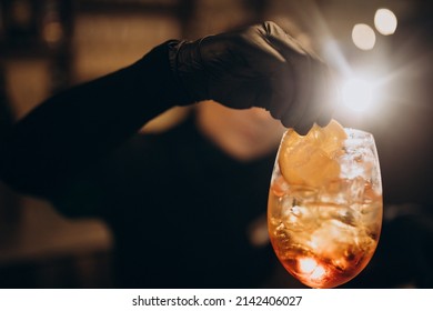 Female Bartender Pouring Champaigne Into Cocktail