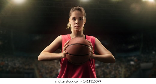 Female Basketball Player With Ball On Big Professional Arena 