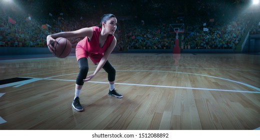 Female Basketball Player With Ball On Big Professional Arena