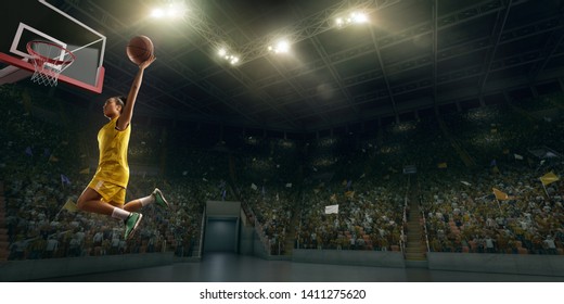 Female Basketball Player Makes Slam Dunk. Basketball Player On Big Professional Arena During The Game