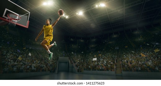 Female Basketball Player Makes Slam Dunk. Basketball Player On Big Professional Arena During The Game