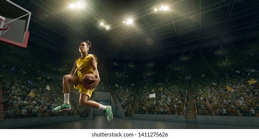 Female Basketball Player Makes Slam Dunk. Basketball Player On Big Professional Arena During The Game