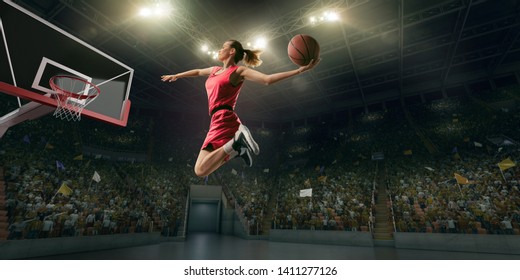 Female Basketball Player Makes Slam Dunk. Basketball Player On Big Professional Arena During The Game