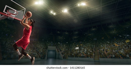 Female Basketball Player Makes Slam Dunk. Basketball Player On Big Professional Arena During The Game