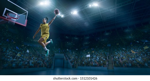 Female Basketball Player Makes Slam Dunk. Basketball Player On Big Professional Arena During The Game