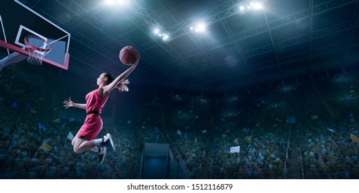 Female Basketball Player Makes Slam Dunk. Basketball Player On Big Professional Arena During The Game