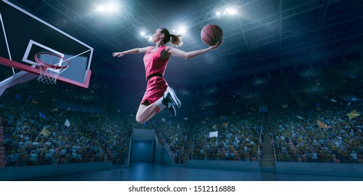 Female Basketball Player Makes Slam Dunk. Basketball Player On Big Professional Arena During The Game