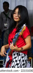 Female Bassist In Glasses With Long Hair Playing Grunge Music At A Political Concert. Tangerang City. Indonesia. Saturday (20-08-2022).