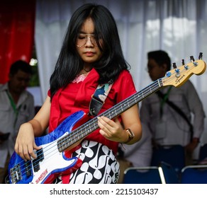 Female Bassist In Glasses With Long Hair Playing Grunge Music At A Political Concert. Tangerang City. Indonesia. Saturday (20-08-2022).