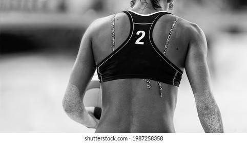 A Female Beach Volleyball Player is Getting Ready to Serve the Ball