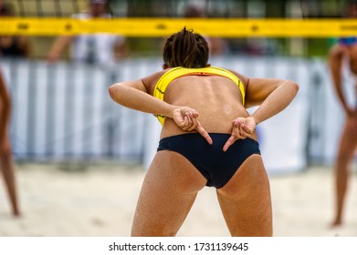 A Female Beach Volleyball Player os Sending Signals to her Teammate - Powered by Shutterstock