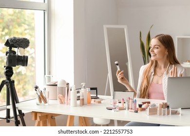 Female Beauty Blogger With Makeup Brush Recording Video In Dressing Room