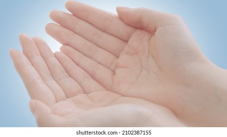 Female Beauty Hands Showing Palms Top View In Giving Or Receiving Gesture. Close-up Clean Background Showing Holding Or Offering Pose Revealing Product Showcase And Copy Space. Young Woman White Skin.