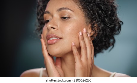 Female Beauty Portrait. Beautiful Multiethnic African American Woman with Afro Hair Posing, Touching Her Natural, Healthy Skin. Wellness and Skincare Concept on Soft Isolated Background. Close Up. - Powered by Shutterstock