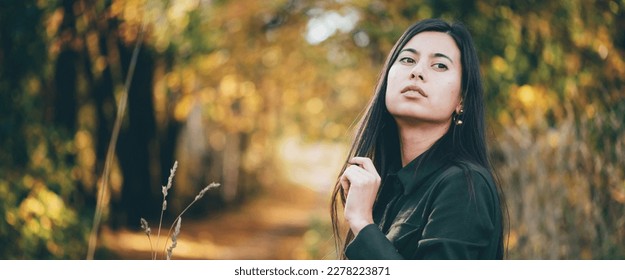 Female beauty portrait surrounded by vivid foliage. Dreamy beautiful girl with long natural black hair on autumn background with colorful leaves in bokeh. Inspired girl enjoys nature in autumn forest. - Shutterstock ID 2278223871
