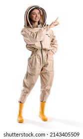 Female beekeeper in protective suit pointing at something on white background