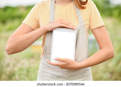 Female Beekeeper With Tablet Computer At Apiary