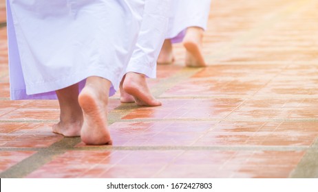Female Bhuddism In White Clothes Walking Slowly, Meditation Tranquil Walk, Without Shoes In The Temple.