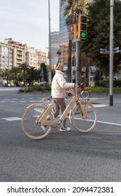 Female Bicyclist Crossing Street In Downtown