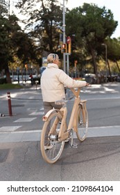 Female Bicyclist Ready To Cross Road