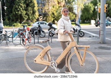 Female Bicyclist Walking On Modern Street