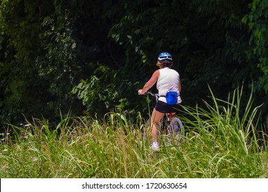 Female Biker Riding On The Katy Trail