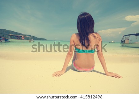 female in bikini on beach vintage retro look without face