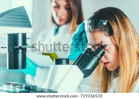 Female biotechnology scientists working in laboratory