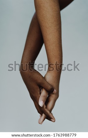 Female black and brown hands entwined. Women of color holding hands showing friendship and support. People of color, hand in hand, diversity, freedom, anti racism concept