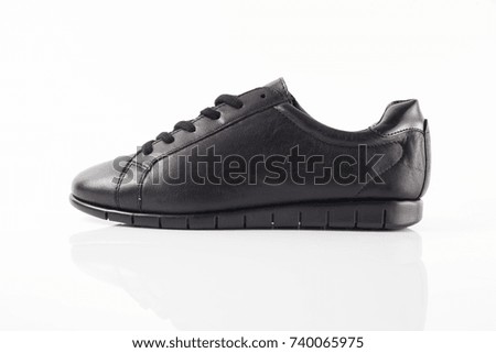 Female black leather elegant shoe on white background, isolated product.