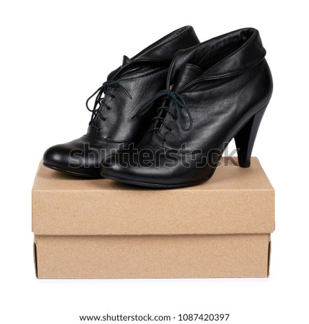 Female black leather high heel shoes with box isolated on white background.