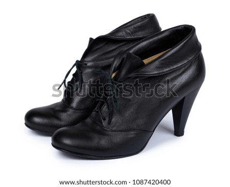 Female black leather high heel shoes isolated on white background.