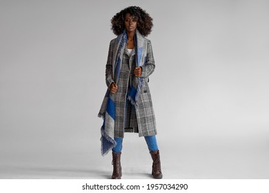 Female Black Model Wear Grey Plaid Coat With Scarf With A Trendy Afro Hairstyle Isoalted On Gray