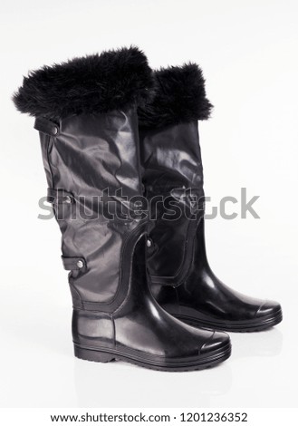 Female black rubber boot on white background, isolated product. 