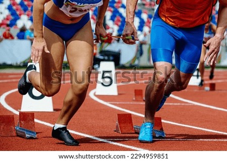 female blind para athlete runner with male guide start running race, summer para athletics championships