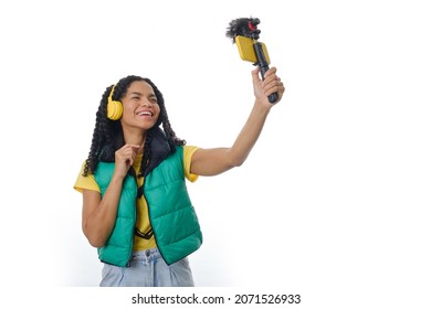 Female blogger creating content for social media while making a video with a smartphone.