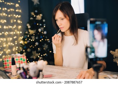 Female Blogger Recording Vlog Video With Makeup Cosmetic In Christmas Time. Online Influencer On Social Media Concept