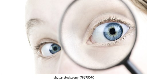 Female Blue Eye Looking Through Magnifying Glass Close Up