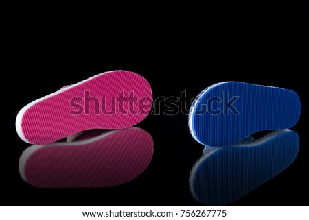 Female blue and pink slipper on black background, isolated product, comfortable footwear.