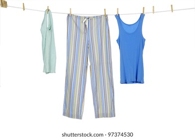 Female Blue Shirt And Trousers Clothespins On Rope