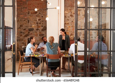 Female Boss Addressing Business Team In A Meeting Room