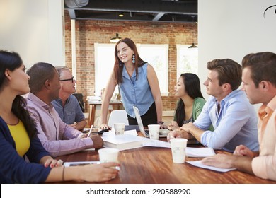 Female Boss Addressing Office Workers At Meeting