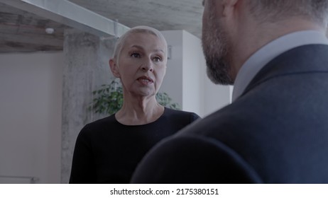 Female Boss Giving Instructions To Male Employee In Office, Strong Woman At Work