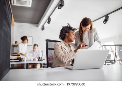 Female boss showing something to her client. - Shutterstock ID 1973990060