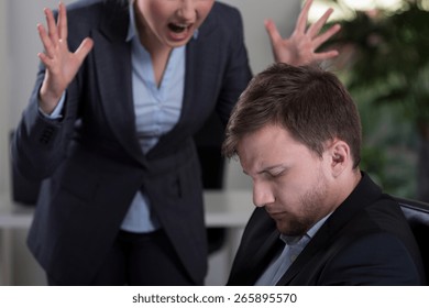 Female Boss Yelling At Employee At Work