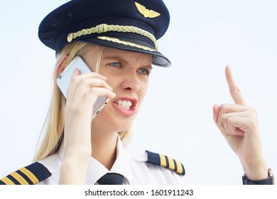 Female Boss Yelling On The Phone In Her Uniform At Work. Woman Stressed At Work Angry On The Phone. 